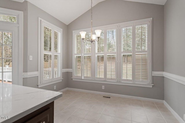 dining area featuring light tile patterned flooring, lofted ceiling, and an inviting chandelier