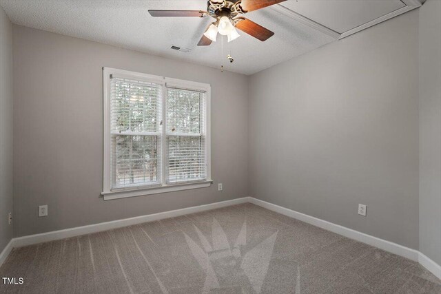 carpeted spare room with ceiling fan and a textured ceiling