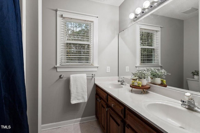 bathroom with vanity, tile patterned floors, a textured ceiling, and toilet