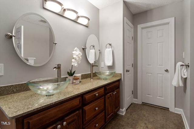 bathroom with vanity and a textured ceiling