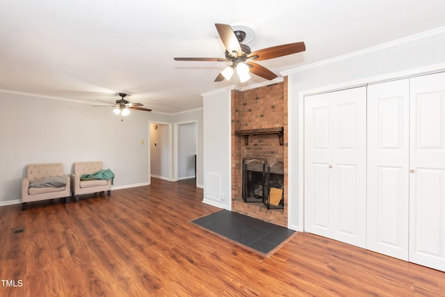 unfurnished living room with dark wood-style floors, a fireplace, baseboards, and crown molding