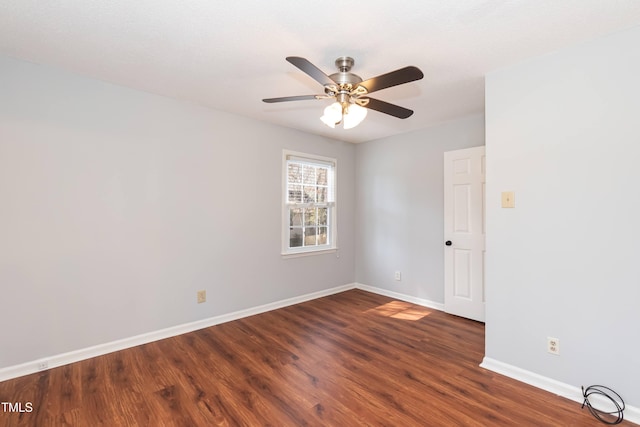 unfurnished room featuring dark wood-style floors, baseboards, and a ceiling fan