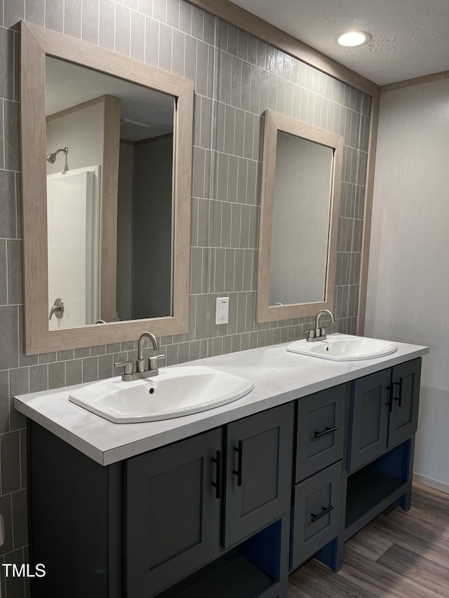 bathroom with vanity, hardwood / wood-style floors, and tile walls