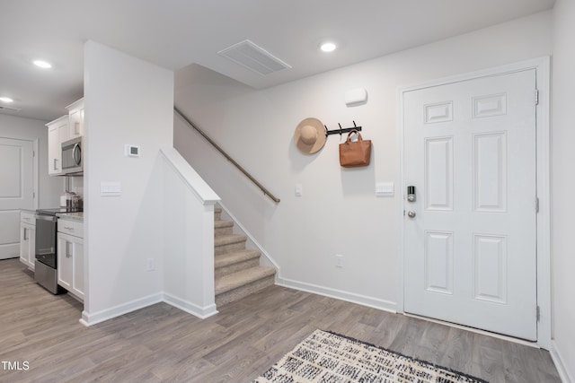 foyer entrance with light hardwood / wood-style floors