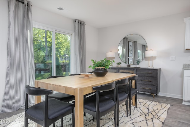 dining space with light hardwood / wood-style floors