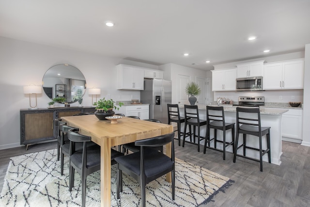 dining space featuring dark wood-type flooring