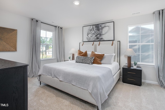 bedroom featuring light carpet