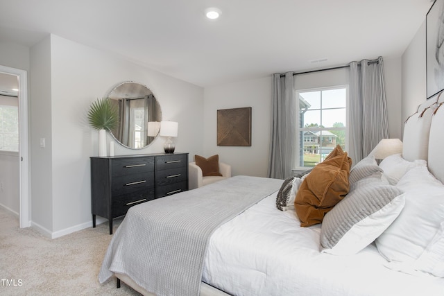 bedroom featuring light colored carpet