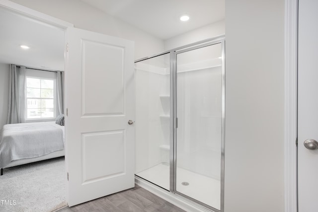 bathroom featuring walk in shower and hardwood / wood-style flooring