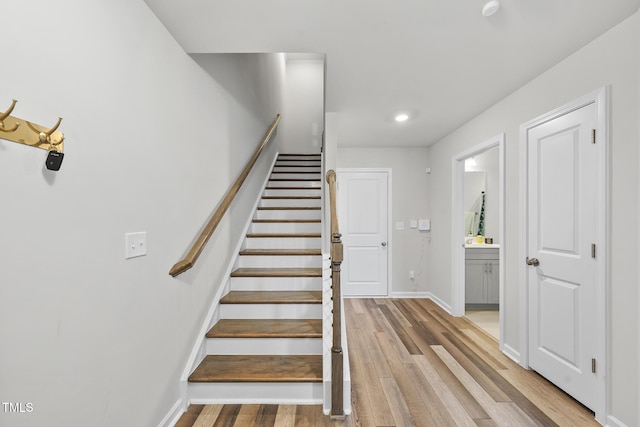 staircase with hardwood / wood-style flooring