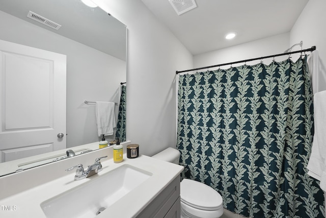 bathroom featuring vanity, toilet, and a shower with shower curtain