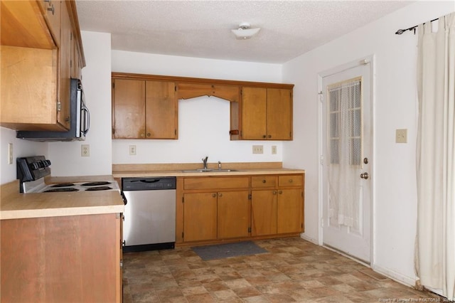 kitchen featuring appliances with stainless steel finishes, sink, and a textured ceiling