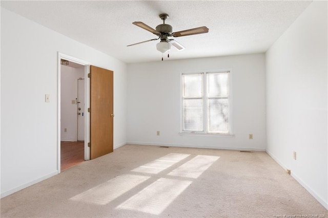 unfurnished room featuring light carpet and ceiling fan