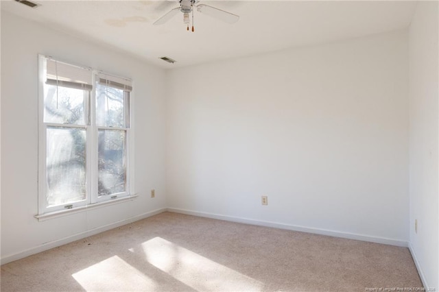 empty room with ceiling fan and light colored carpet