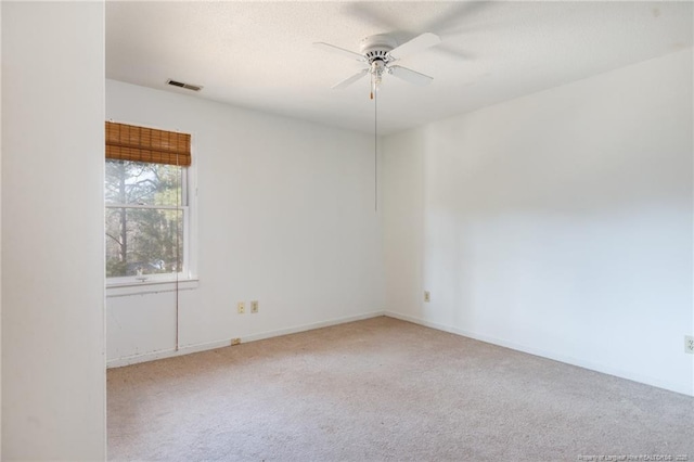 carpeted spare room with ceiling fan