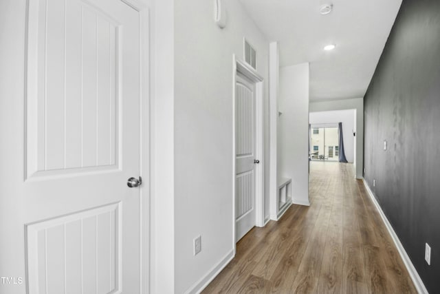 hallway with wood-type flooring