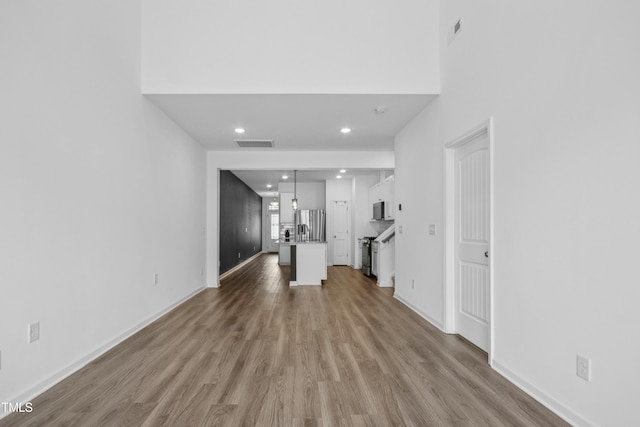 unfurnished living room with light hardwood / wood-style flooring