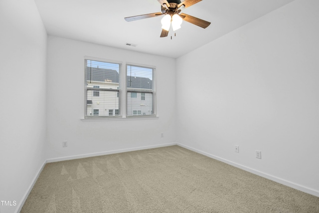 spare room featuring carpet flooring and ceiling fan