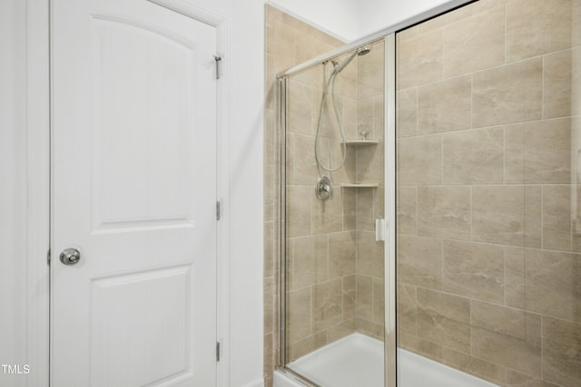 bathroom with a shower with shower door