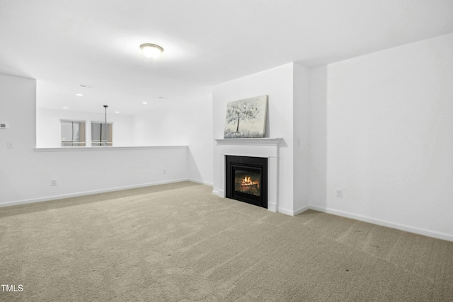 unfurnished living room with light colored carpet