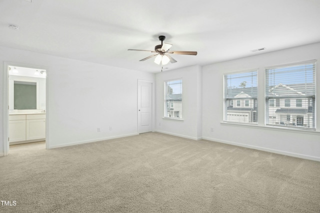 spare room featuring ceiling fan and light colored carpet