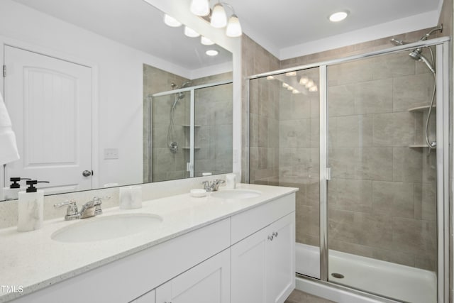 bathroom with an enclosed shower and vanity