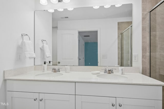 bathroom with vanity and an enclosed shower