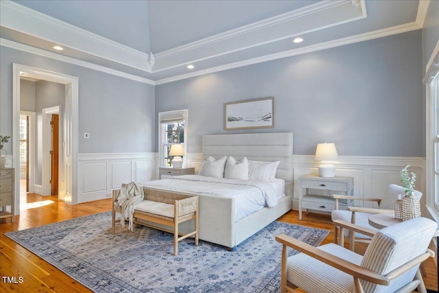 bedroom with recessed lighting, a wainscoted wall, crown molding, and light wood-style flooring