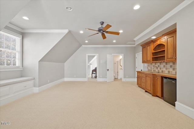 interior space featuring recessed lighting, light carpet, a sink, and baseboards