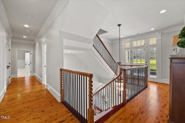 corridor with baseboards, recessed lighting, wood finished floors, and crown molding