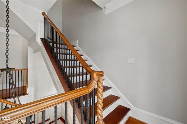 staircase featuring baseboards