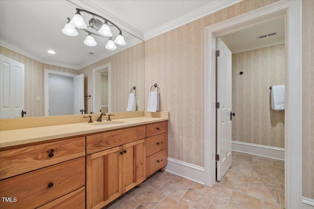 bathroom featuring crown molding, visible vents, vanity, baseboards, and wallpapered walls