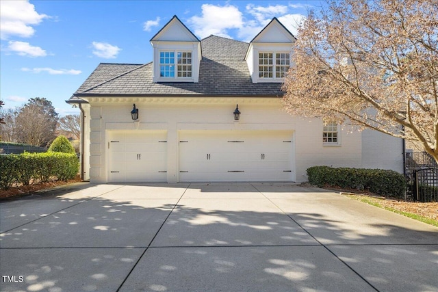 view of side of home featuring a garage and driveway