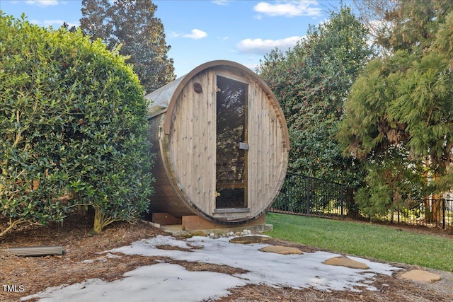 view of outbuilding with fence