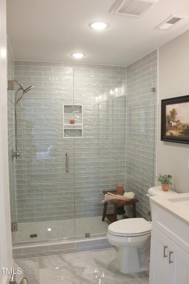 bathroom with vanity, an enclosed shower, and toilet