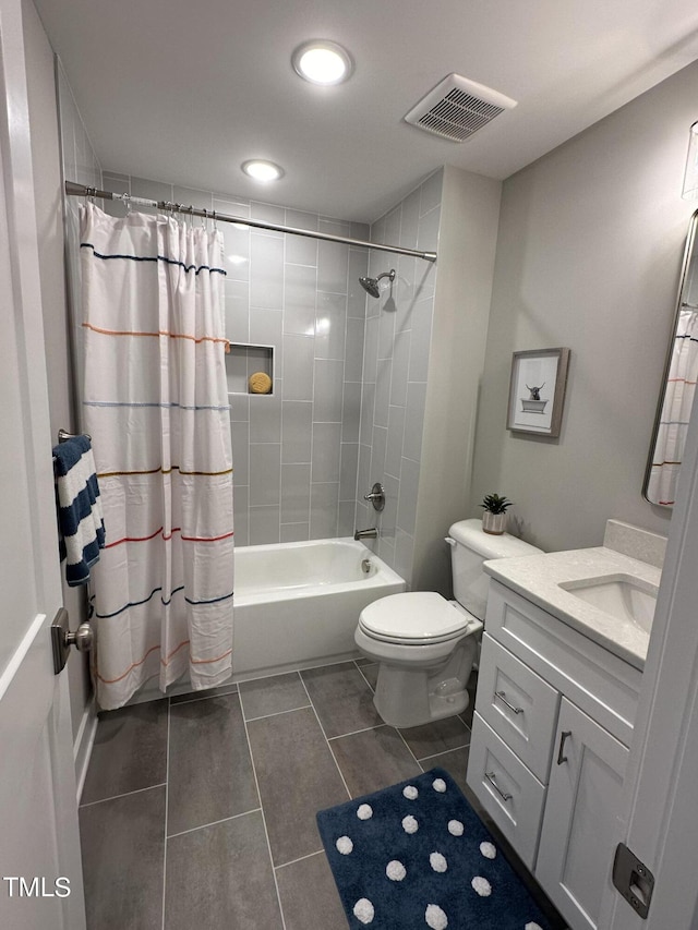 full bathroom featuring shower / tub combo with curtain, vanity, toilet, and tile patterned floors