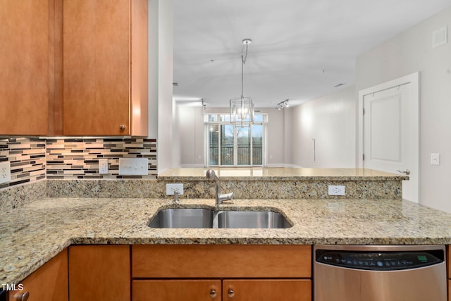 kitchen featuring dishwasher, light stone countertops, sink, and backsplash