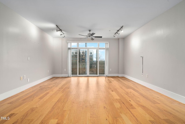 unfurnished room with ceiling fan, track lighting, and light hardwood / wood-style flooring