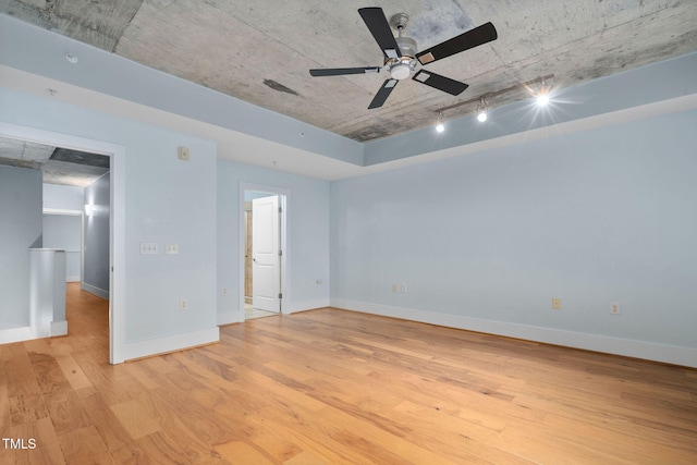 spare room with ceiling fan, rail lighting, and light hardwood / wood-style floors