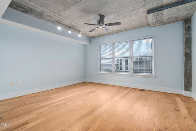 unfurnished room featuring ceiling fan, track lighting, and light wood-type flooring