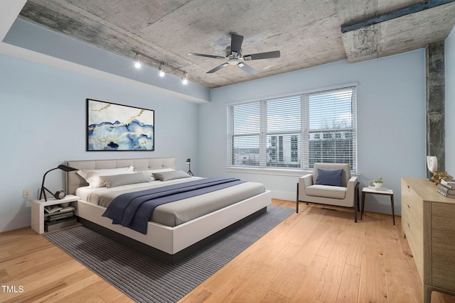 bedroom with ceiling fan, track lighting, and light wood-type flooring