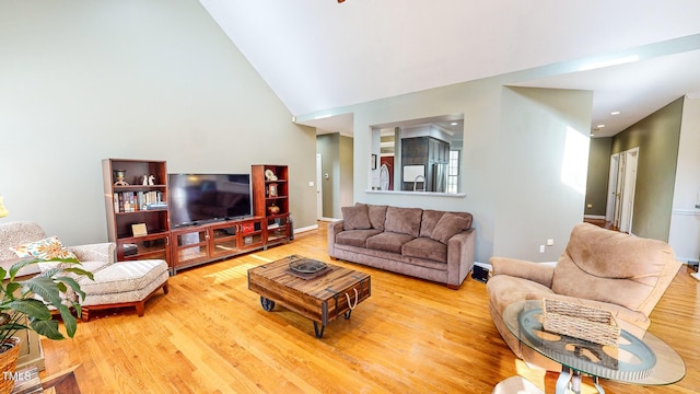 living room with wood-type flooring and vaulted ceiling