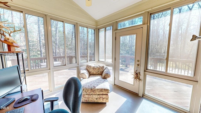 sunroom / solarium featuring lofted ceiling and plenty of natural light