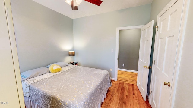 bedroom with ceiling fan and light wood-type flooring