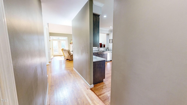 hallway featuring sink and light hardwood / wood-style flooring