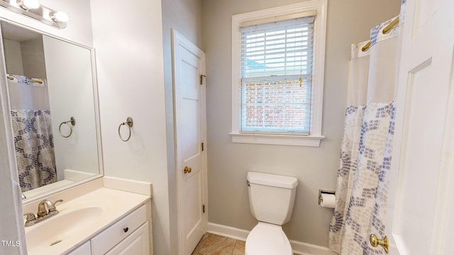 bathroom with tile patterned flooring, vanity, and toilet