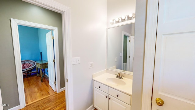 bathroom featuring hardwood / wood-style flooring and vanity