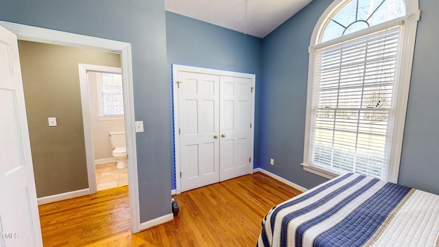 bedroom featuring wood-type flooring and a closet