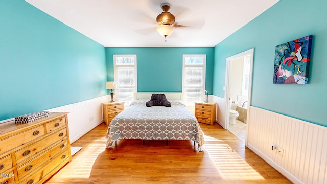 bedroom featuring connected bathroom, ceiling fan, and light hardwood / wood-style flooring