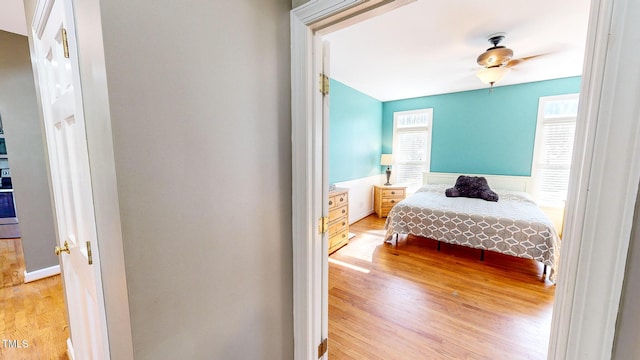 bedroom with light wood-type flooring and ceiling fan